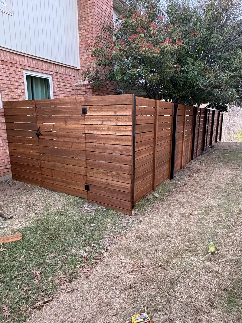 Horizontal stained wood fence with a matching walk gate and black hardware